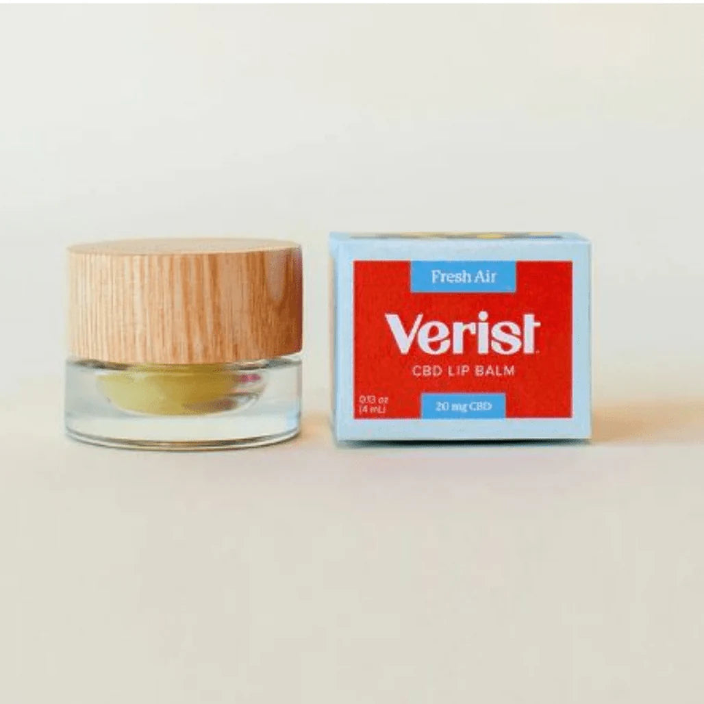 Verist Fresh Air CBD Lip Balm 20mg CBD in a glass jar with wooden lid next to its red and blue box